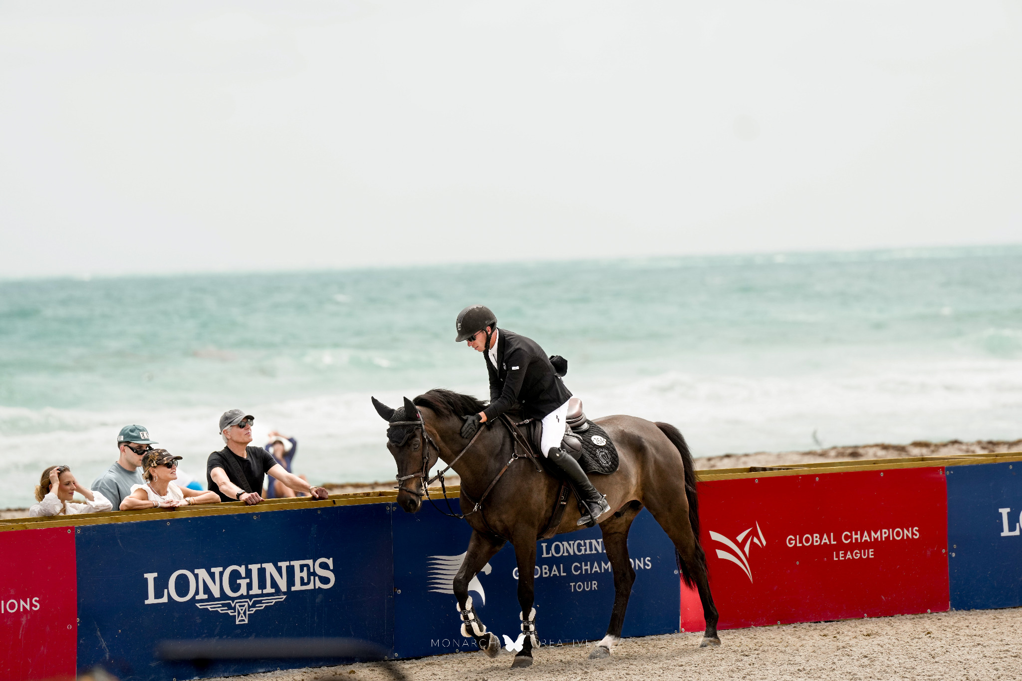 Spencer Brittan riding beside the arena at an international competition